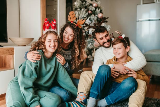 Sesión de fotos navideña; familia posando feliz para su foto de navidad